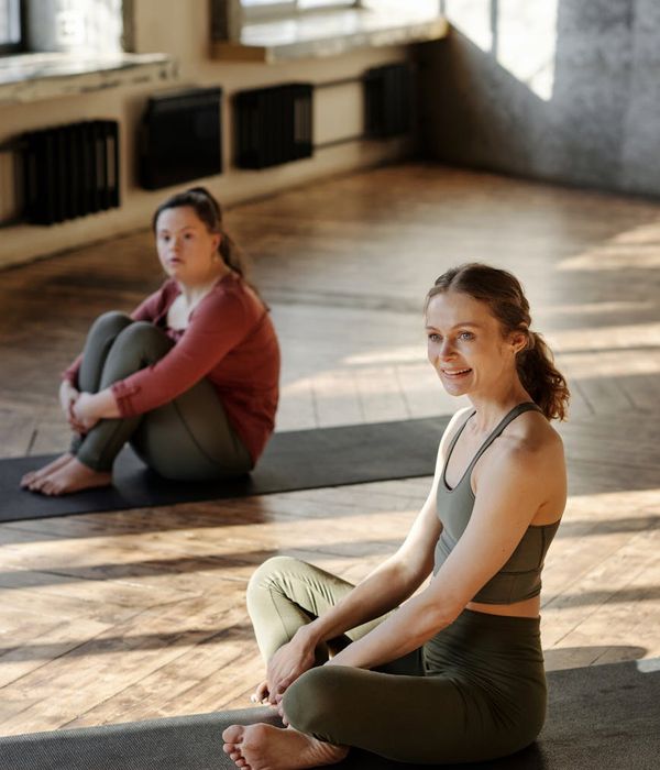 Woman in a calm yoga pose, surrounded by a peaceful ambiance.